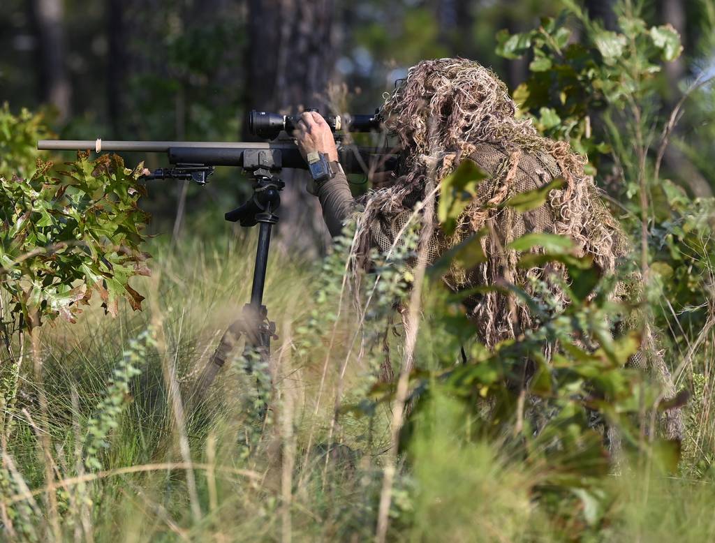 US Army Sniper rifle and ghillie suit